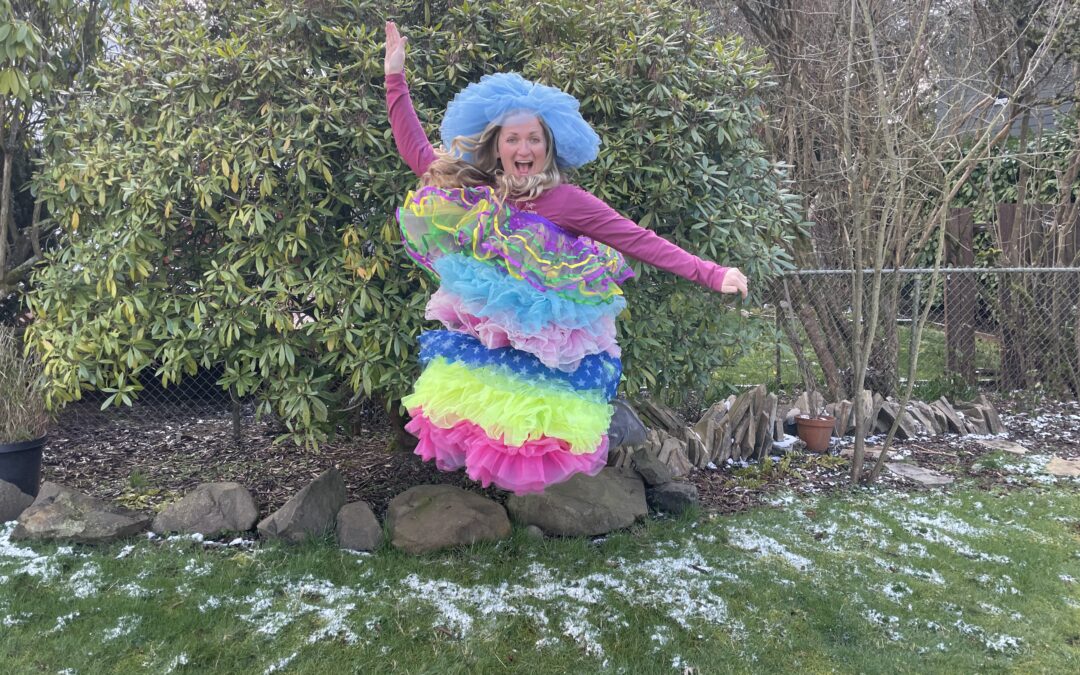 A woman dressed in alternating color of tutus, jumping in the air.