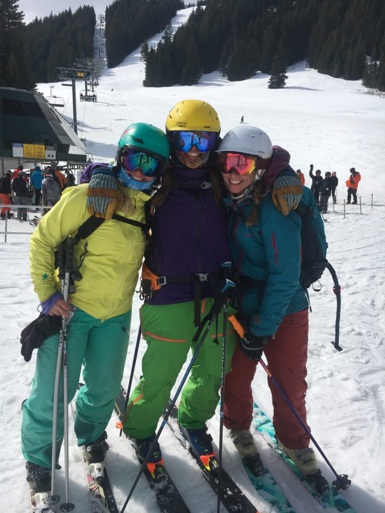 Three women standing in ski gear.