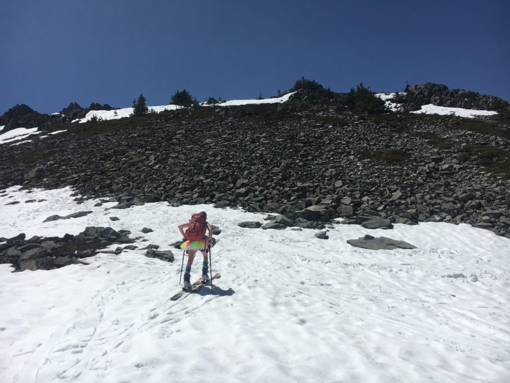 A tutu-clad skier looks toward the summit of Silver Peak.