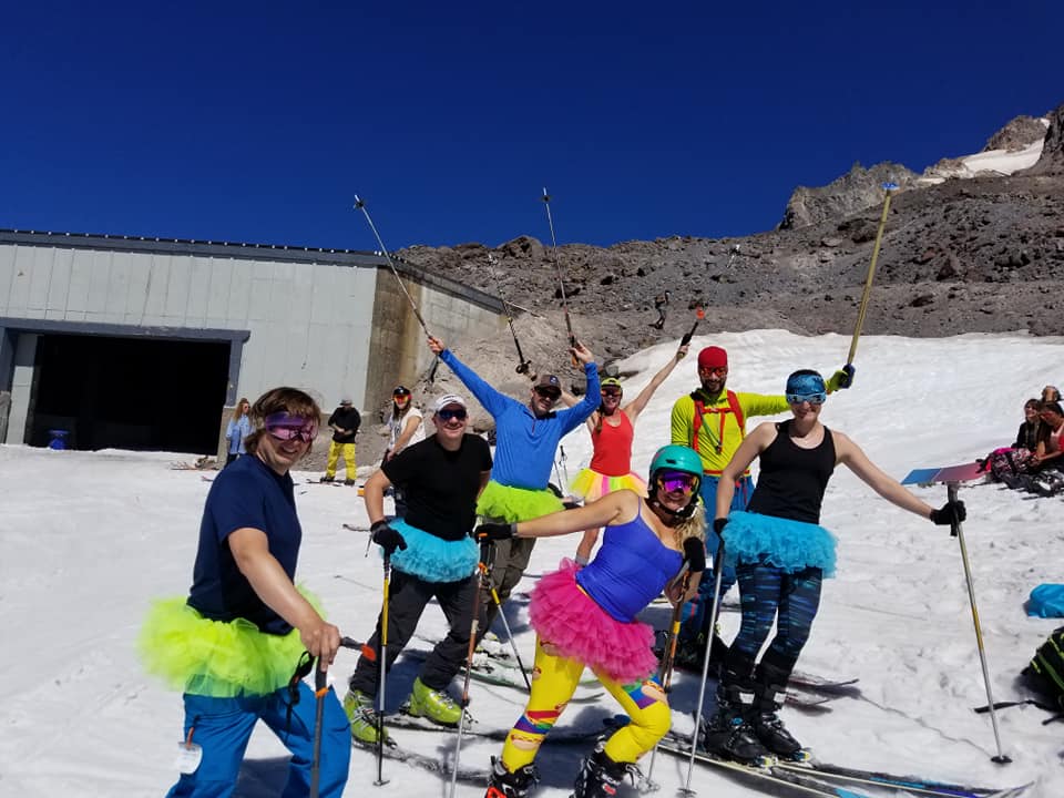 A very colorful group of skiers celebrating Turns All Year.
